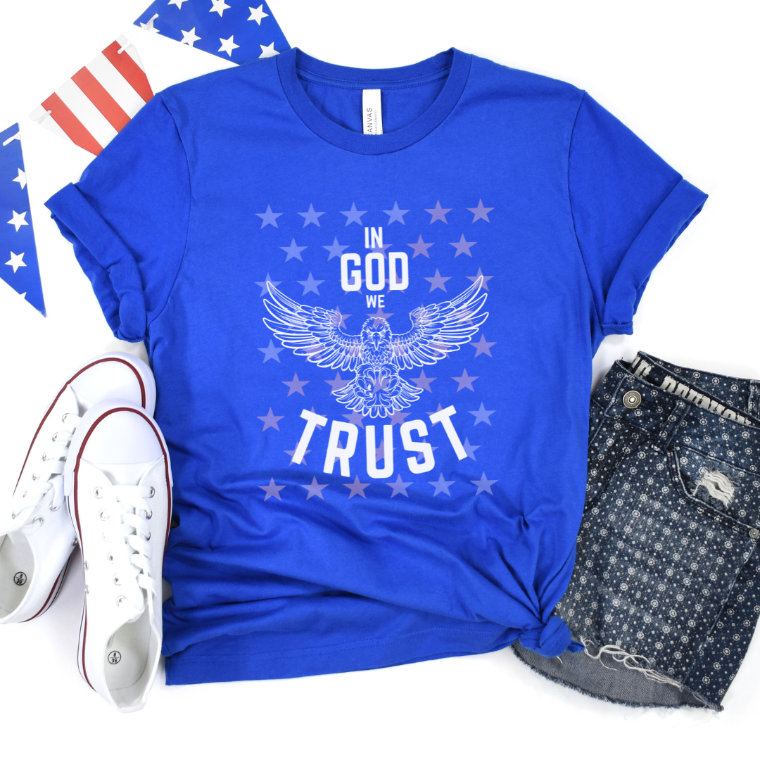 Show your love for God and country with our patriotic women's Christian t-shirt featuring a majestic eagle and the words 'In God We Trust'. Available in black and royal blue with a stunning star overlay it's the perfect July 4th graphic tee. Great for any proud American Christian woman! 