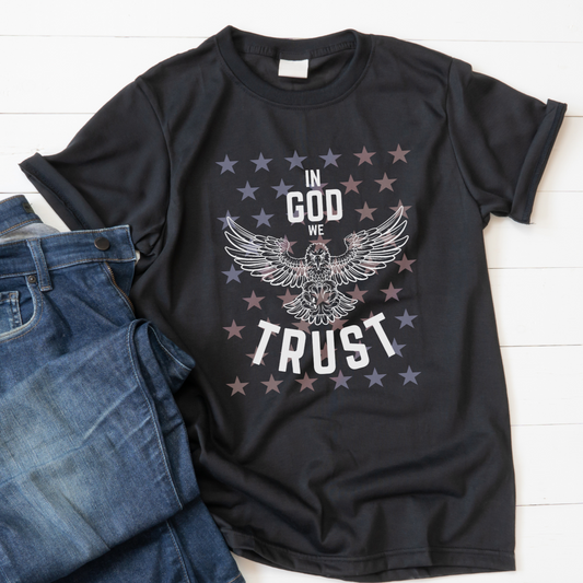 Show your love for God and country with our patriotic women's Christian t-shirt featuring a majestic eagle and the words 'In God We Trust'. Available in black and royal blue with a stunning star overlay it's the perfect July 4th graphic tee. Great for any proud American Christian woman! 